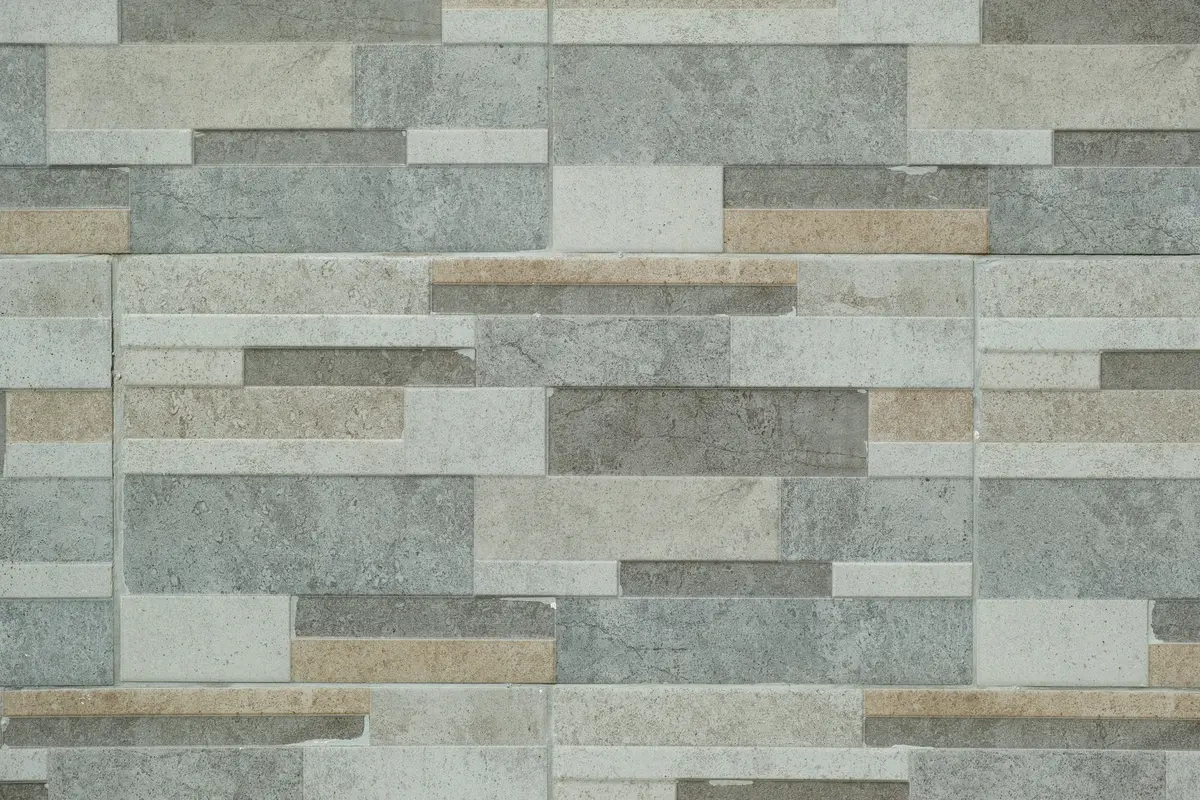 Stacked stone-look wall tile in layered grey tones