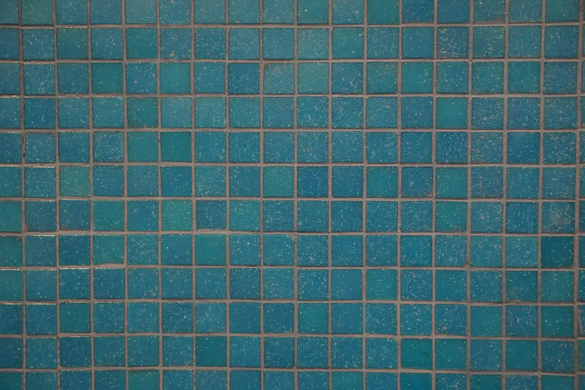 Close-up of teal square mosaic tile with even grout joints