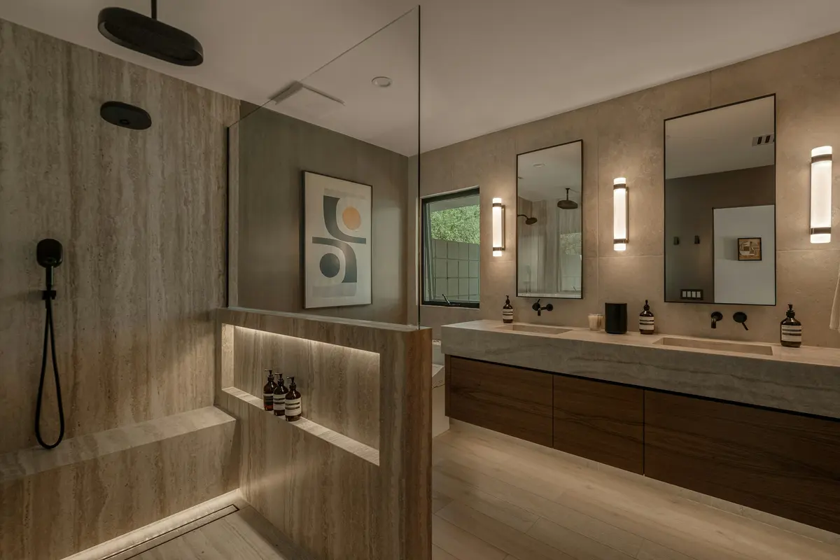 Bathroom with large-format stone-look wall tile, a walk-in shower and a floating wood vanity